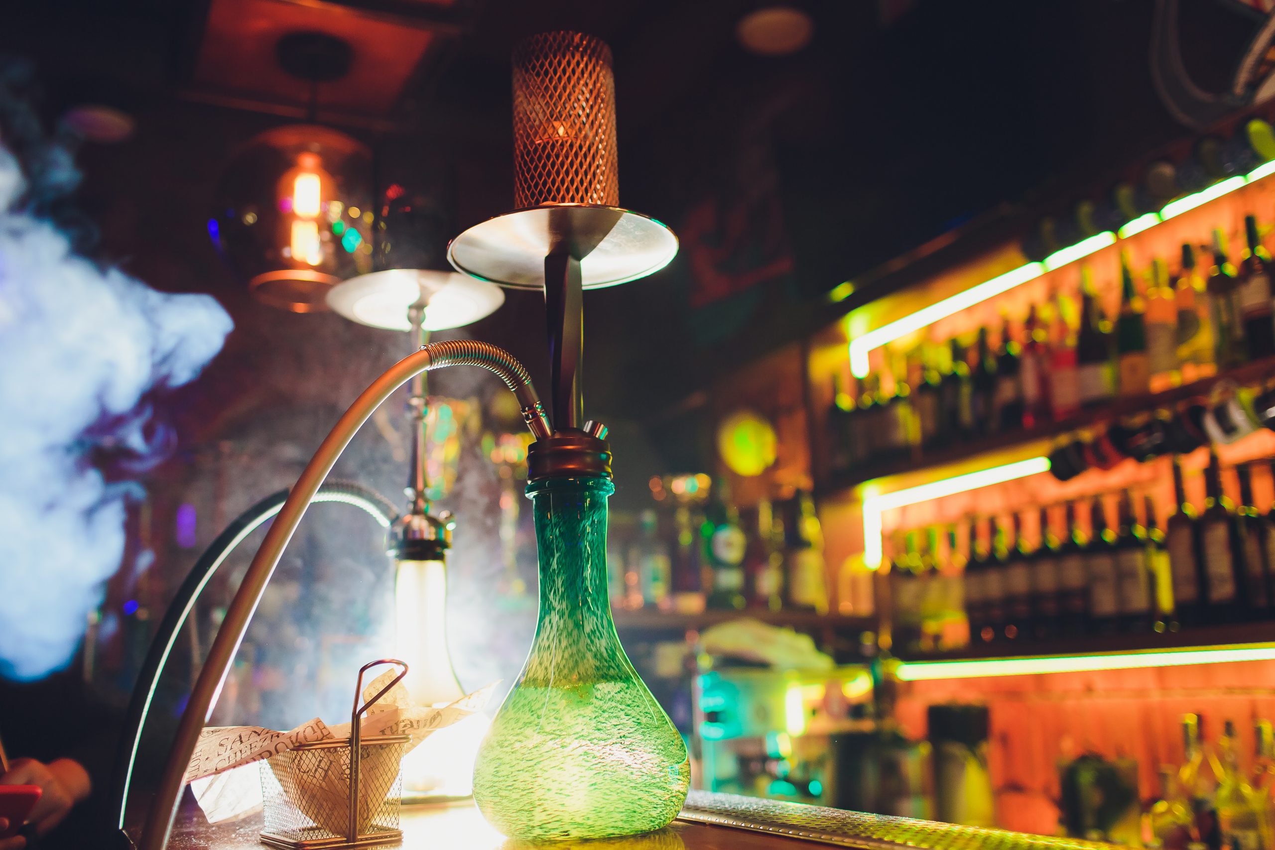 Process of making hookah for smoking. concept of smoking a hookah and having a good time. hookah bowl on the dark background of the bar close up view. Toned image